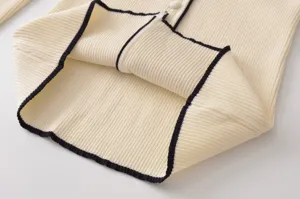 Detalle de cárdigan de punto, ribete de contraste jersey de manga larga de cerca