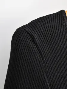 Black ribbed knit top fabric detail view, comfortable stretch material for women fashion.