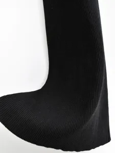 Close-up of black ribbed knit fabric showing fine texture and elasticity for pants.