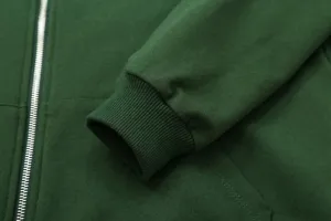 Close-up detail of dark green women zip hoodie sleeve cuff and metallic zipper texture.