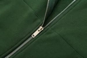 Close-up detail view of dark green zip-up hoodie featuring smooth metal zipper and soft fabric.