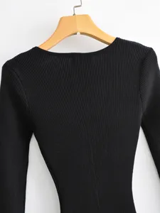 Black ribbed knit long sleeve top detail showing texture and collar construction on hanger.