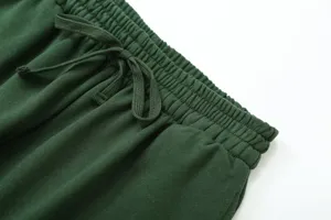 Dark green sweatpants elastic waistband drawstring detail close up casual fashion view