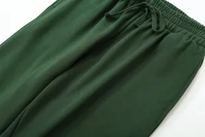 Detailed view of dark green casual sweatpants with elastic drawstring waistband for women.