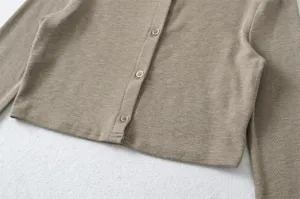 Close-up detailed view of women's khaki knit cardigan featuring front buttons and soft texture.