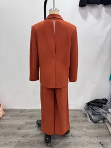 Orange corduroy suit set for women, featuring a casual blazer and wide-leg trousers.