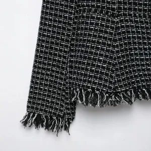 Stylish black and white tweed blazer for women featuring chic fringed hem and classic texture.