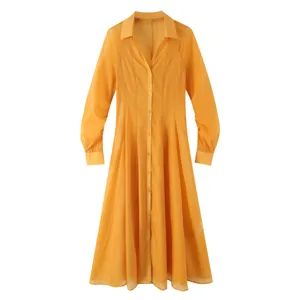 Details of the elegant yellow sheer long-sleeve V-neck shirt dress with textured fabric.