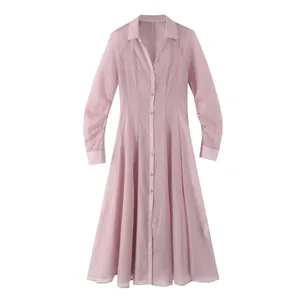 Close-up view of the pink long-sleeve shirt dress, sheer textured fabric and button details.