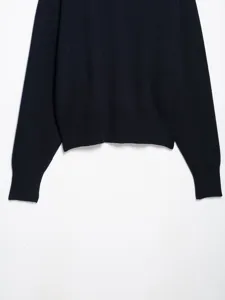 Dark blue knit sweater detail showing ribbed hem and long sleeves for women fashion.