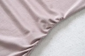 Close-up detail shot of women's stylish ruched strapless top fabric, soft texture.