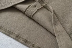 Close-up view of women's knitted fabric and neat edge stitching texture detail shot.