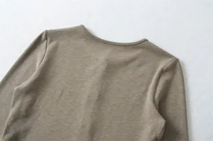 Detailed view of the Korean style solid color knitted top collar and shoulder design.