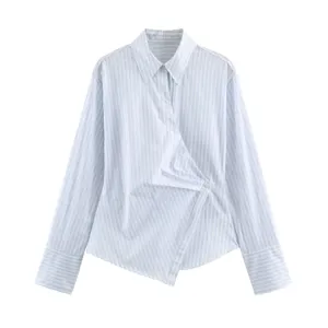 Details of the blue white striped long sleeve asymmetrical wrap front shirt with button closure.