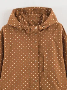 Brown polka dot hooded windbreaker jacket with snap buttons and drawstring detail.