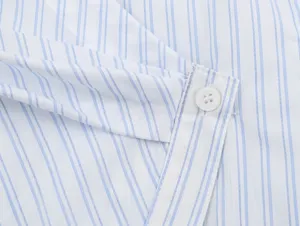 Blue and white striped women's shirt detail view with button and diagonal placket design.