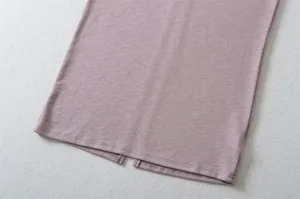 Dusty pink knitted skirt hem detail featuring a stylish back slit design for women.