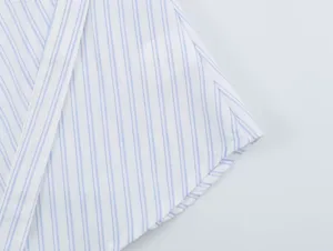 Blue and white striped shirt detail, casual asymmetric button-up design for women.