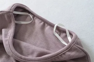 Close-up detail of women ribbed camisole strap in dusty purple, soft knit fabric texture.