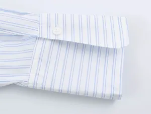 Blue and white striped shirt cuff detail, classic long sleeve buttoned design for women.
