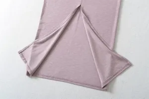 Close-up detail of women's knit split midi skirt hem in mauve, showing fine texture and stitching.