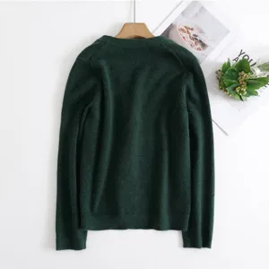 Dark green V-neck knitted cardigan detail view, showing soft texture and classic long sleeves.