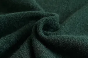 Detailed close-up view of premium dark green knitted wool cardigan fabric texture detail.