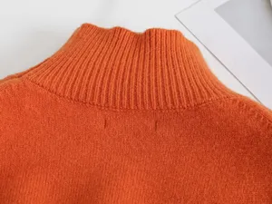Orangefarbene Rollkragen Pullover Kragen Detail, weiche Strickstoff Textur, warme Winter Kleidung.