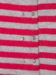Close-up detail of women's knitted cardigan featuring pink and grey stripes and pearl buttons.
