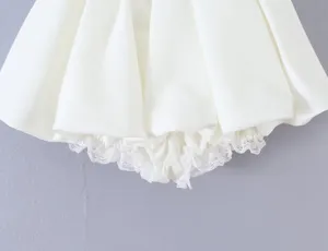 White bubble skirt detail view, featuring delicate lace trim on the hem. Perfect style.