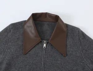 Grey knit cardigan featuring contrast brown faux leather lapel collar and front zipper detail.