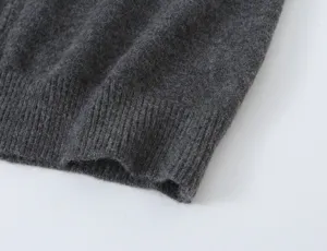 Close up detail of dark gray knit sweater cuff showcasing soft texture and fine stitching.