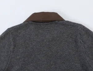 Close-up detail of women's dark grey knitted cardigan featuring a contrast brown leather collar.