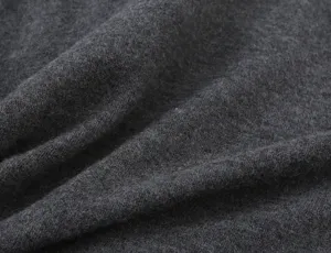 Dark grey knit cardigan fabric detail shot showing soft texture and fine fuzzy woolen surface.