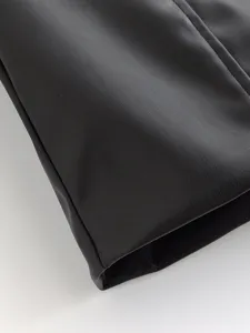 Black faux leather fabric detail texture close up view precision stitching craft