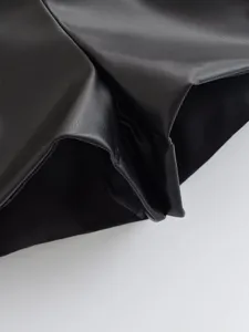Black PU leather shorts detail view, high waist design, premium texture and stylish look.