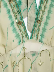 Women halter neck backless top with tie-dye print and sequin bead embroidery detail.