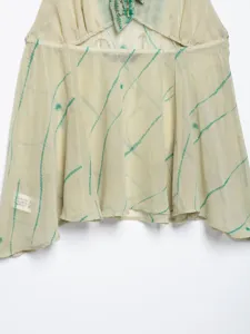 Detailed view of the halter neck backless top featuring unique green print and delicate embroidery.