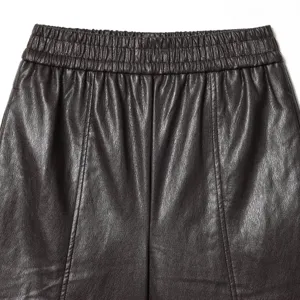 Women faux leather casual shorts in dark brown with elastic waist and stylish center seam.
