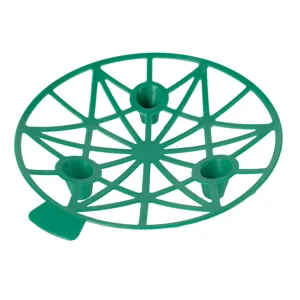 Detail view of the green plastic melon fruit support tray, showing mesh structure and legs.