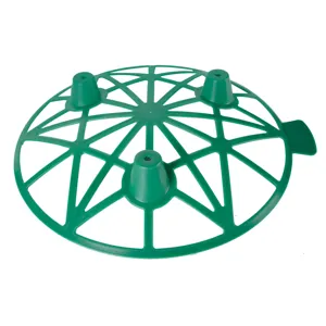 Green plastic melon support tray detail, garden fruit protection cradle with stable grid feet.