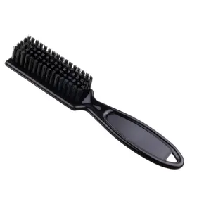 Black barber fade brush detail showing soft nylon bristles and ergonomic handle for styling.