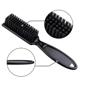 Closeup view showing dense soft bristles and handle profile of the black barber styling brush.