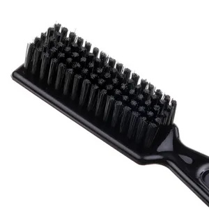 Close-up detail shot of professional barber hair brush with soft black nylon bristles for styling.