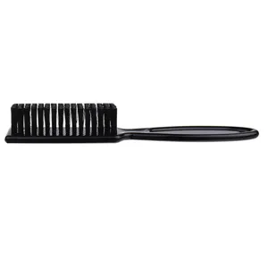 Close-up detail of the black barber brush featuring soft bristles and ergonomic plastic handle.