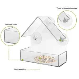Clear acrylic bird feeder with three strong suction cups, drainage holes, and deep seed tray.