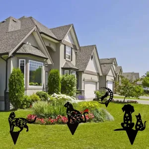 Detailed view of metal cat and dog yard art stakes with hollow floral patterns for garden decor.