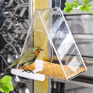 Clear acrylic window bird feeder with feeding tray and perch for outdoor wild birds use.