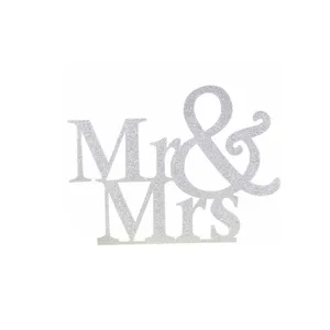 Silver glitter Mr & Mrs cake topper detail showcasing sparkling wedding dessert decoration.