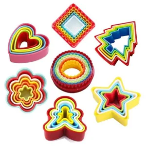 Plastic cookie cutter set nested baking molds shaped like stars, hearts, and flowers.